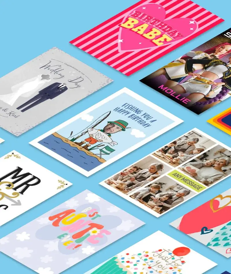 Colorful greeting cards arranged on a light blue background, featuring various designs, patterns, and celebratory messages. Colorful greeting cards arranged on a light blue background, featuring various designs, patterns, and celebratory messages.